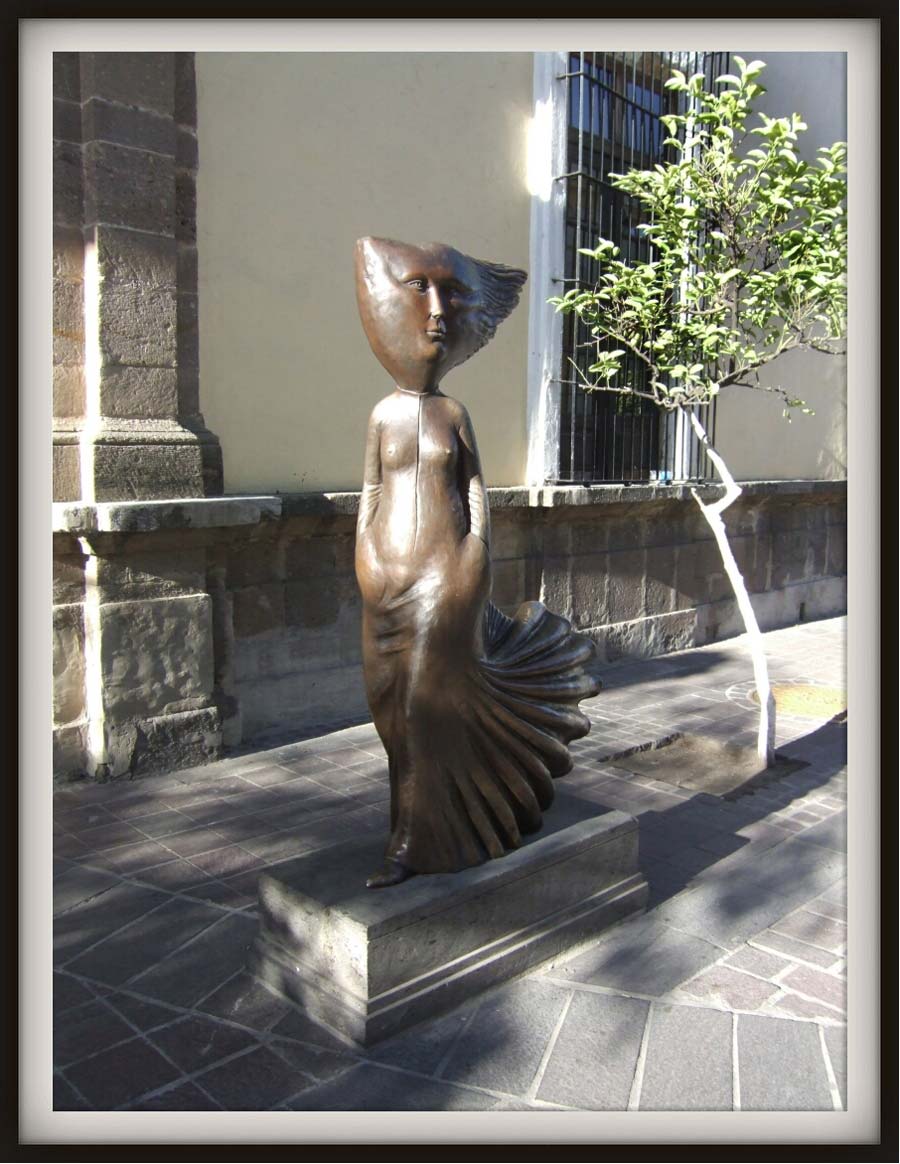 Sergio Bustamante, christened Sergio Emilio Edgardo De Bustamante Roa y Arteaga (b. 1942 in Culiacan, Sinaloa, Mexico). Embrace of the wind. Bronze. Delante de la Sergio Bustamante Gallery: Calle Independencia  238, Tlaquepaque, Guadalajara, Jalisco, Mexico (cerca de la  MuseoRegionaldelaCerámica: Calle Independencia  237).