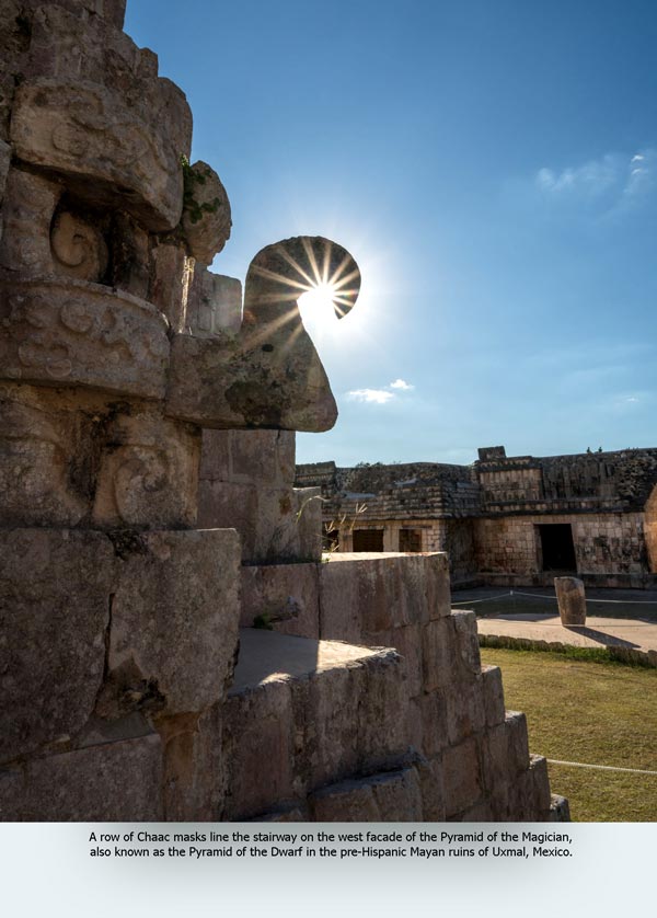 A row of Chaac masks line the stairway on the west facade of the Pyramid of the Magician, also known as the Pyramid of the Dwarf in the pre-Hispanic Mayan ruins of Uxmal, Mexico.