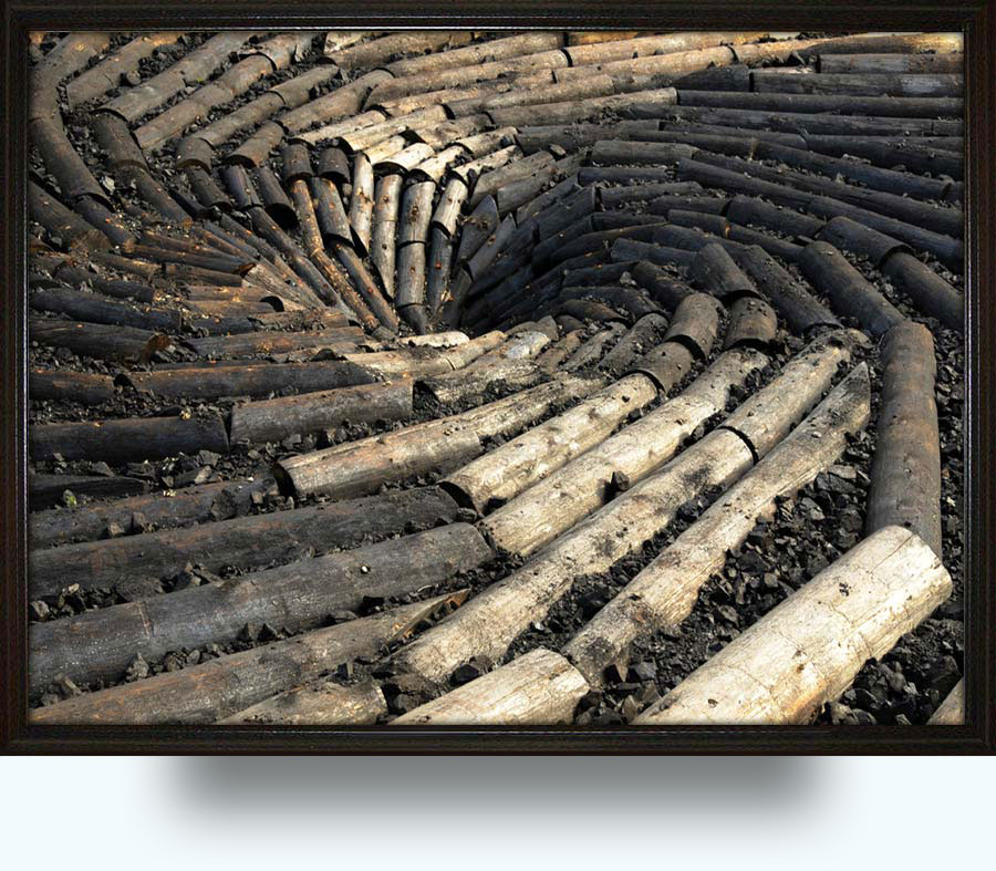 Chris Drury (b. 1948 in Colombo, Sri Lanka). Carbon Sink. 2011. University of Wyoming. A flat whirlpool of beetle-killed logs spiraling into a vortex of charred, black wood and studded with large lumps of Wyoming coal. Thirty-six feet in diameter, it will be just south of Old Main, near the intersection of 10th Street and Ivinson Avenue.